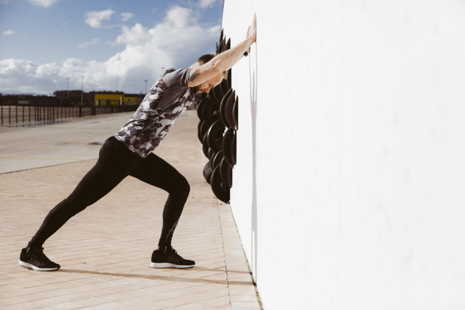 A parkour enthusiast warming-up before vaults practice.