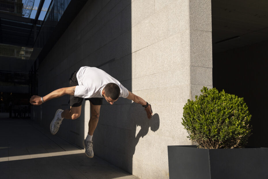 A showing off parkour complex move with full focus.