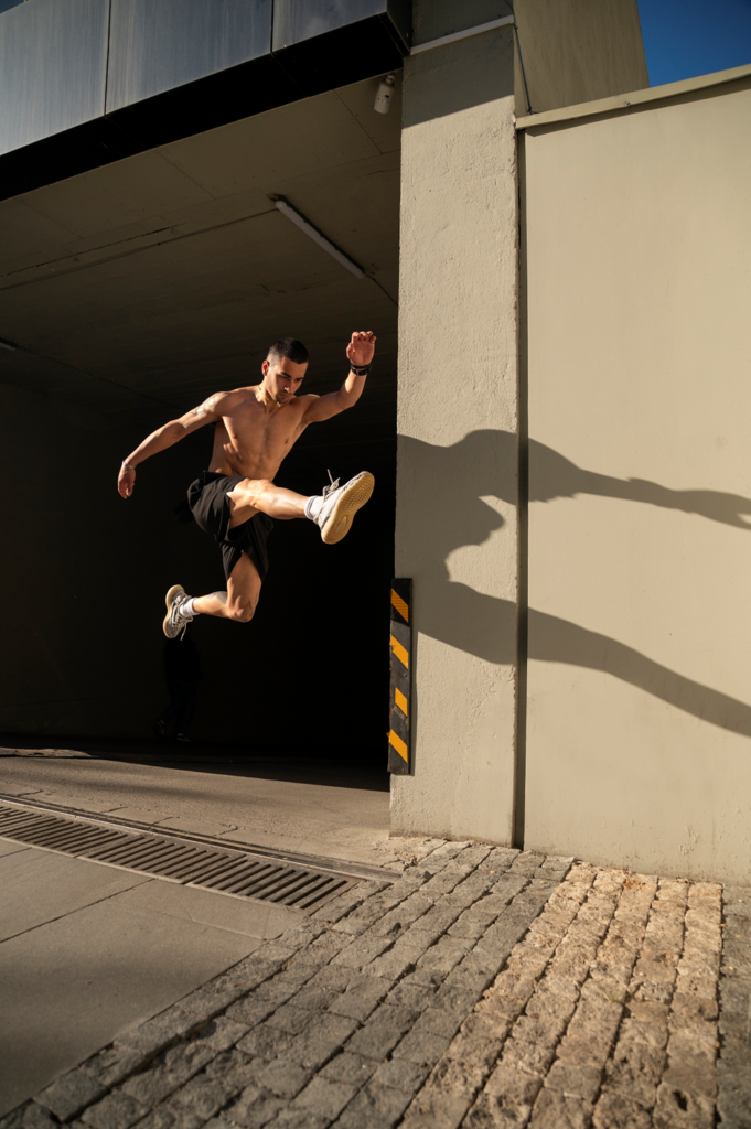 A man practicing parkour speedy jump vault.