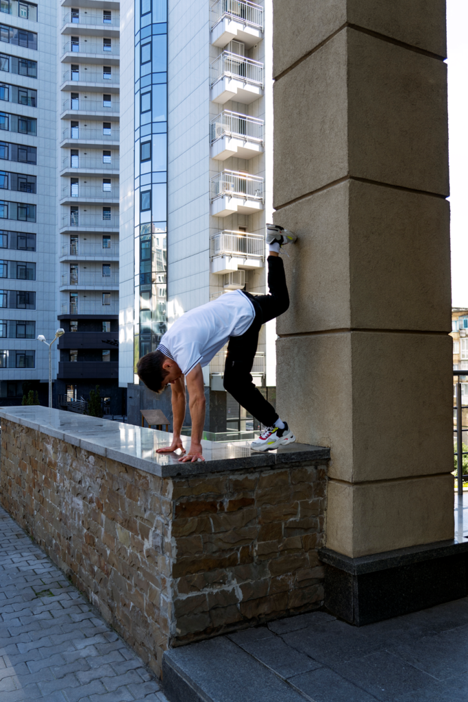 A man practicing parkour vaults.