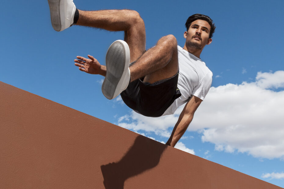 A man practicing for wall flipping during parkour.