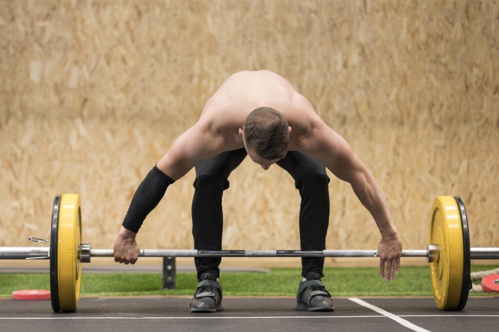 A parkour enthusiast lifting weight during practice.