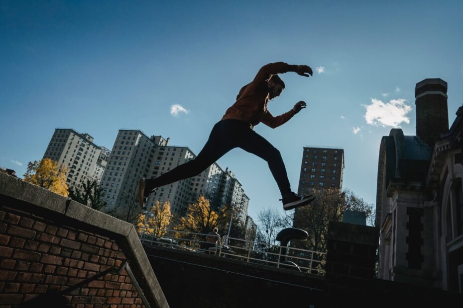 A traceur performing an explosive jump, demonstrating plyometric power.