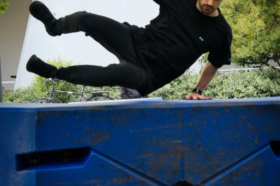 A parkour athlete vaulting over an obstacle in a park.