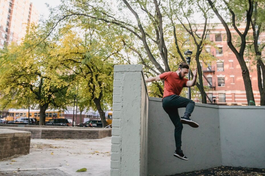 A traceur pushing off a wall face during a wall run.
